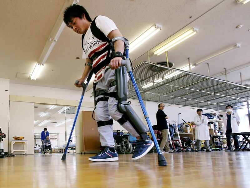 This picture taken on April 17, 2015 shows Yuichi Imahata walking with the help of a robotic exoskeleton called ReWalk at Kanagawa Rehabilitation Center in Atgugi, west of Tokyo. Shuji Kajiyama/AP Photo