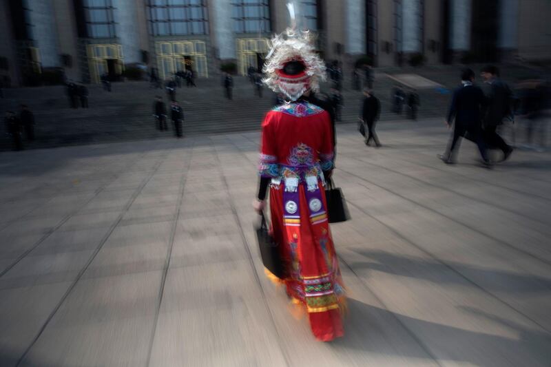 A Chinese minority delegate arrives at the 13th National People's Congress (NPC) at the Great Hall of the People in Beijing. Fred Dufour / AFP Photo