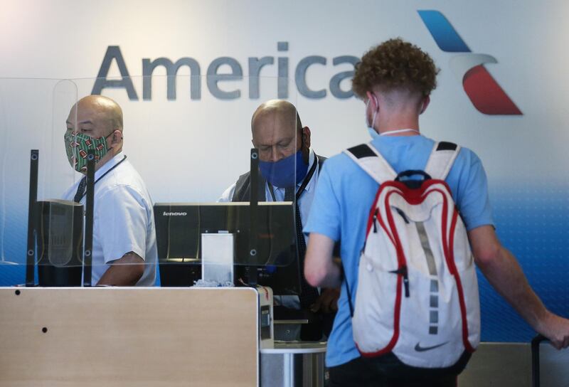American Airlines employees work in a check-in area at Los Angeles International Airport in Los Angeles, California. AFP