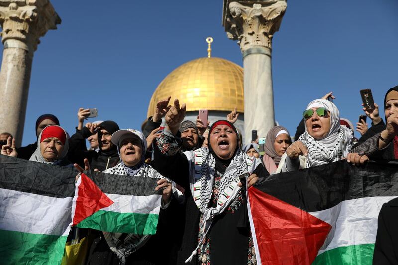 Worshippers chant as they hold Palestinian flags after Friday prayers in Jerusalem's Old City. Ammar Awad / Reuters