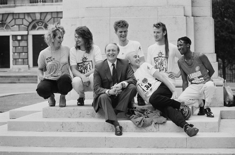 Mr Kinnock with a group of youngsters publicising Labour's jobs And industry campaign in 1985