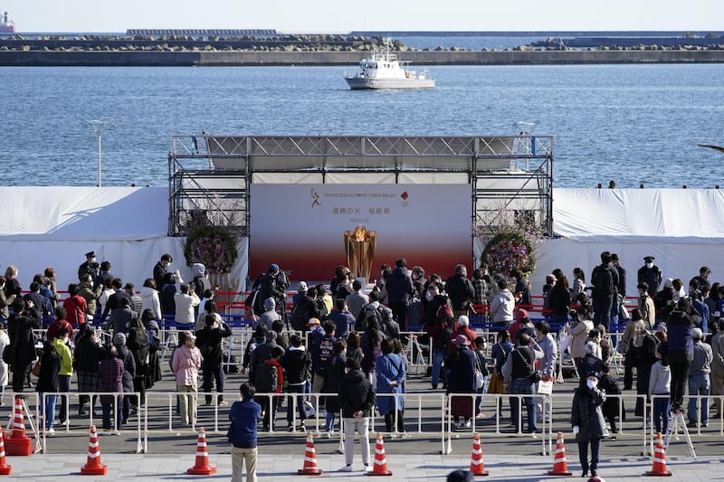 Visitors queue to see the Olympic Flame during a ceremony in Iwaki, Fukushima. AP