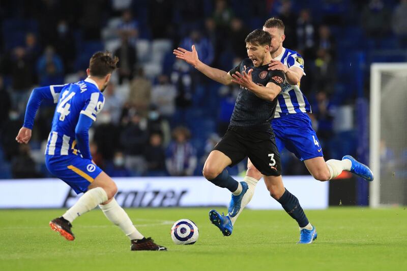 Dias challenges for the ball with Brighton's Adam Webster. AP