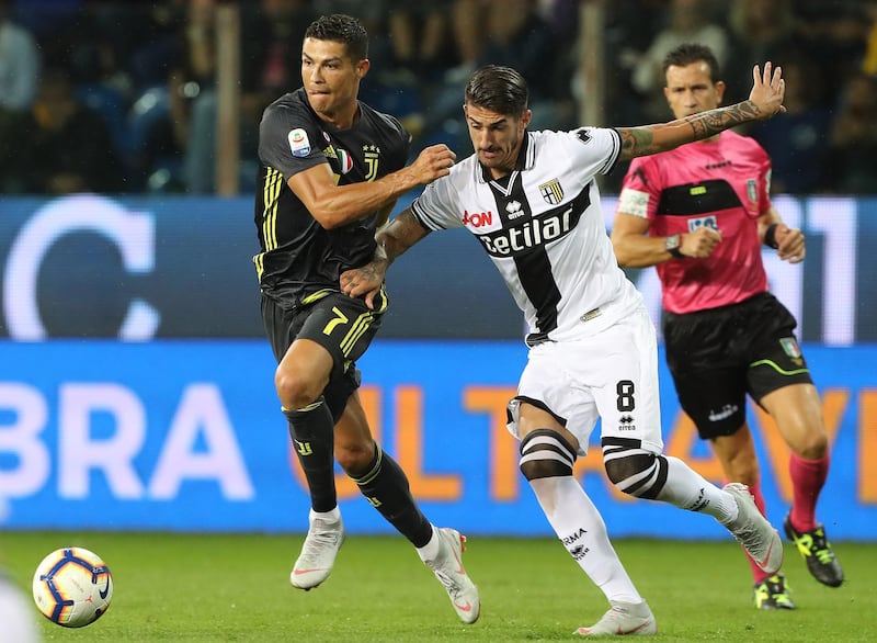 Cristiano Ronaldo tussles with Alessandro Deiola during the Serie A match between Juventus and Parma. Getty Images