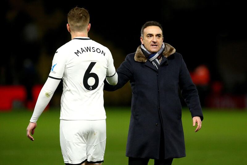 WATFORD, ENGLAND - DECEMBER 30: Swansea Manager Carlos Carvalhal celebrates the teams win with Alfie Mawson after the final whistle during the Premier League match between Watford and Swansea City at Vicarage Road on December 30, 2017 in Watford, England. (Photo by Charlie Crowhurst/Getty Images)