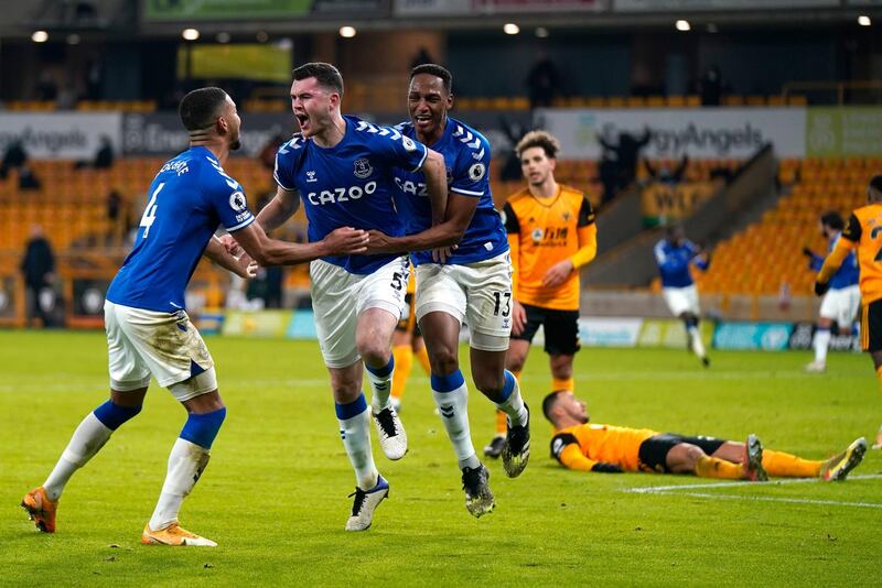Everton's Michael Keane, centre, celebrates after scoring his side's second goal during the English Premier League soccer match between Wolverhampton Wanderers and Everton at the Molineux Stadium in Wolverhampton, England, Tuesday, Jan.12, 2021. (Tim Keeton/Pool via AP)
