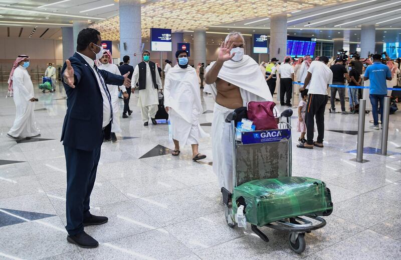 Mask-clad Pakistani travellers arriving in Saudi Arabia to perform the year-round Umrah pilgrimage. AFP