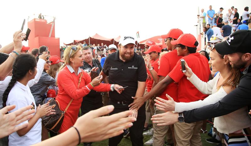 Lowry is mobbed by spectators as he leaves the course.