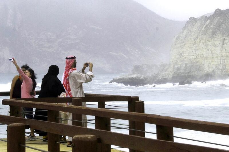 Visitors take pictures during their visit to Mughsail Beach in Salalah. Randolph Caguintuan / Reuters