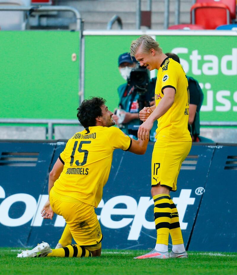 Erling Braut Haaland, right, is congratulated by Dortmund's German defender Mats Hummels. AFP