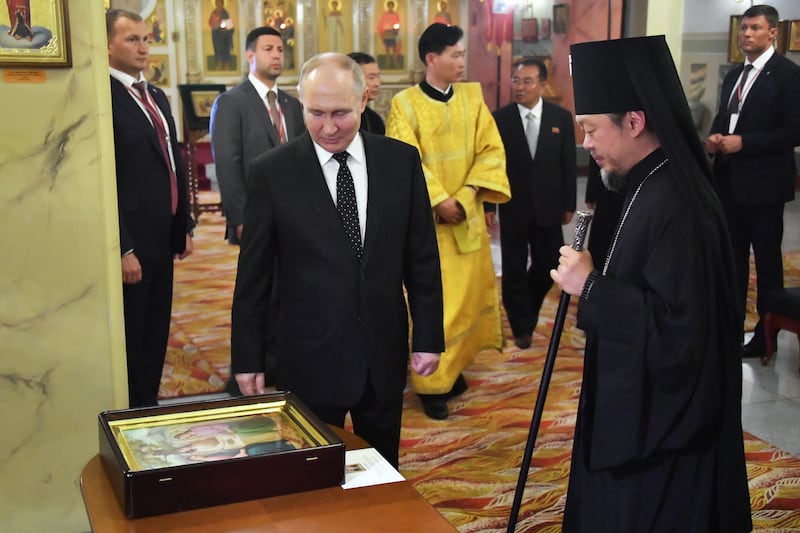 Mr Putin visits the Church of the Holy Life-Giving Trinity, in Pyongyang. EPA