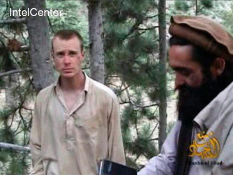 US Army soldier Bowe Bergdahl, left, with a Taliban commander in a video released by the Taliban in 2010. Sgt Bergdahl was released from captivity in Afghanistan in exchange for five Afghan prisoners held at the US prison at Guantanamo Bay in Cuba. EPA / Intelcenter