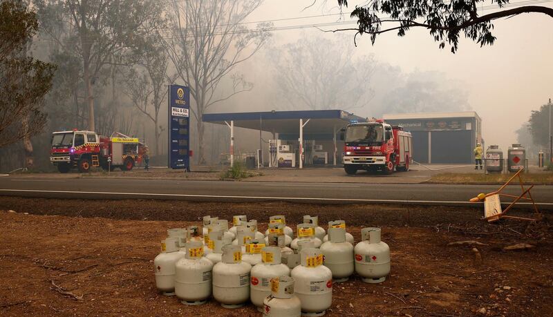 LPG cylinders sit on the ground after being moved away from a service station by firefighters along Old Bar road in Old Bar, New South Wales, Australia.  EPA