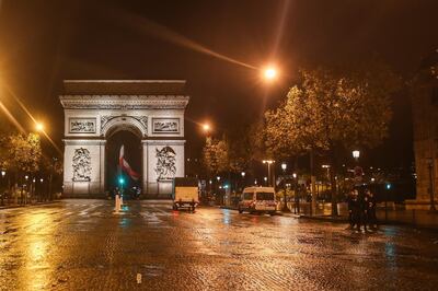 epa08779411 A police car stops next to the Arc de Triomphe on anight shift to control the night curfew, in Paris, France, October 27, 2020. President Emmanuel Macron will unveil new measures to stop the Covid-19 epidemic on the eve of October 28. 2020.  EPA/MOHAMMED BADRA