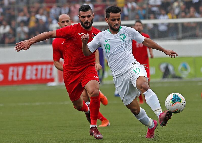 Palestine's Musab Battat in action with Saudi Arabia's Abdulfattah Asiri  - FIFA World Cup 2022 and Asian Cup Qualifier - Palestine v Saudi Arabia - Faisal Al-Husseini International Stadium, Al-Ram, West Bank. REUTERS