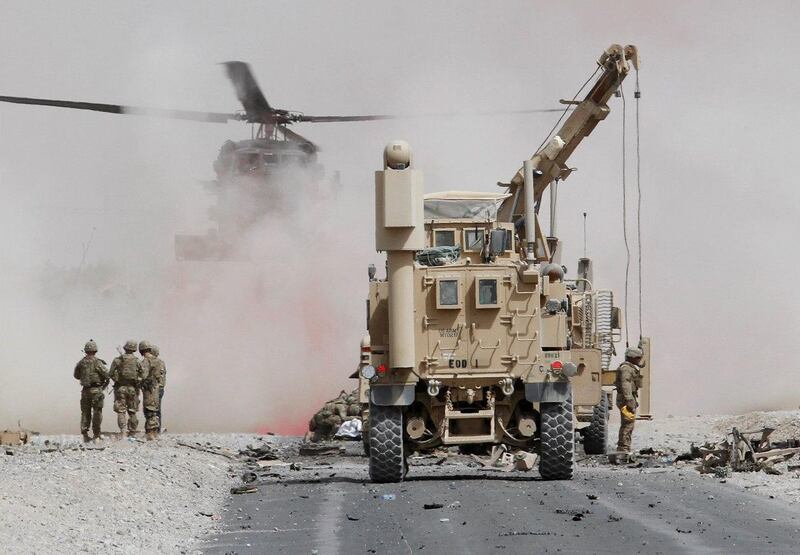 U.S. troops assess the damage to an armoured vehicle of NATO-led military coalition after a suicide attack in Kandahar province, Afghanistan August 2, 2017.REUTERS/Ahmad Nadeem     TPX IMAGES OF THE DAY