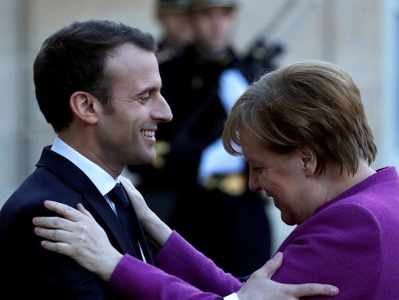 FILE PHOTO: FILE PHOTO: French President Emmanuel Macron welcomes German Chancellor Angela Merkel as she arrives for a meeting at the Elysee Palace in Paris, France, March 16, 2018. REUTERS/Christian Hartmann -/File Photo/File Photo