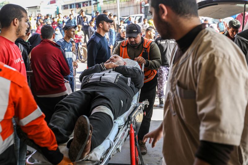 Palestinians wounded in Israeli air strikes arrive at Nasser  Hospital. Getty Images