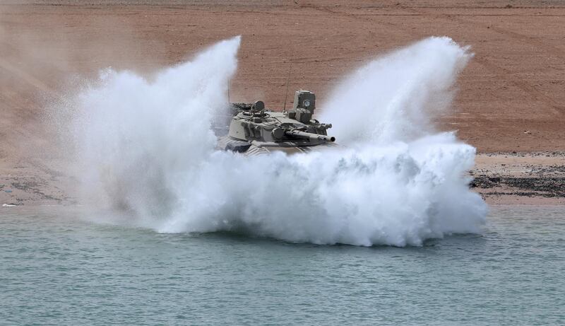 An Emirati armoured personnel carrier charges into the water