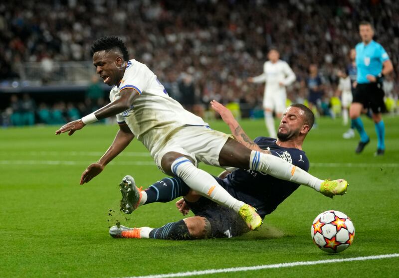 Real Madrid's Vinicius Junior battles for the ball with Manchester City's Kyle Walker. AP