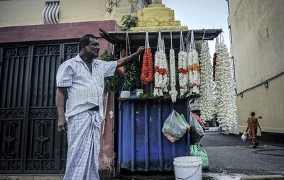 Navaratnam, a Tamil flower garland seller, looks out to the street in Bambalapitiya, Colombo. Jack Moore/The National