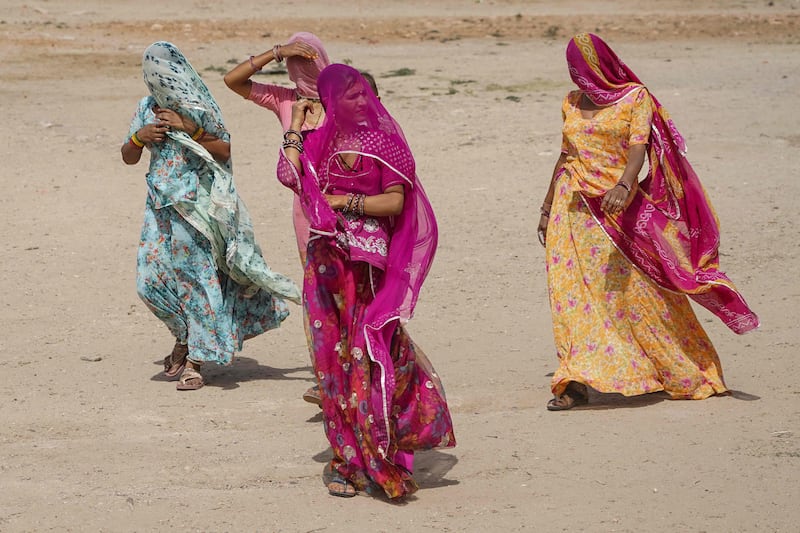 Women walk to a polling station to cast their ballot in the first phase of voting for India's general election in Parbatsar, Rajasthan. AFP