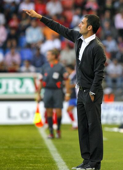 Barcelona's coach Jopep Guardiola gestures during a Spanish league soccer match against Numancia at Los Pajaritos Stadium in Soria, Spain, on Sunday, Aug. 31, 2008. (AP Photo/I.Lopez)