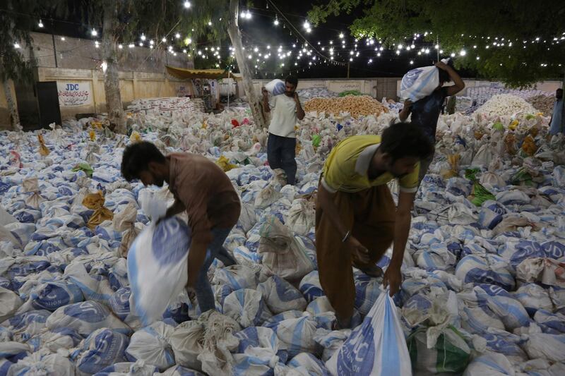 Volunteers prepare food packets in Karachi, Pakistan. AP Photo