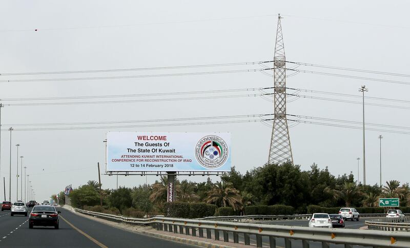 A picture taken on February 9, 2018 shows a billboard welcoming guests participating in the Kuwait International Conference for Reconstruction of Iraq, along a highway in the capital Kuwait City. / AFP PHOTO / YASSER AL-ZAYYAT