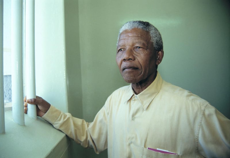Nelson Mandela revisited the cell at Robben Island prison where he was jailed for more than two decades. Currently, his optimistically brightly colored pastel lithographs of his cell and cell window have sold well to enthusiastic bidders at "Touch of Mandela" auctions internationally. All proceeds go to the Nelson Mandela Trust, in support of his charitable causes. (Photo by Louise Gubb/Corbis via Getty Images)