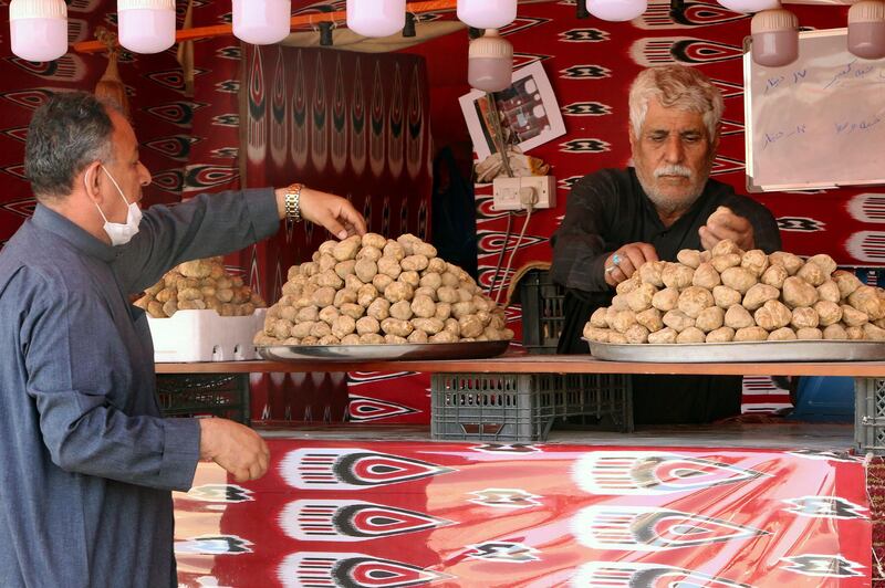 A customer selects desert truffles in Kuwait City. The truffles are boiled in rice dishes or chargrilled on open fires. AFP