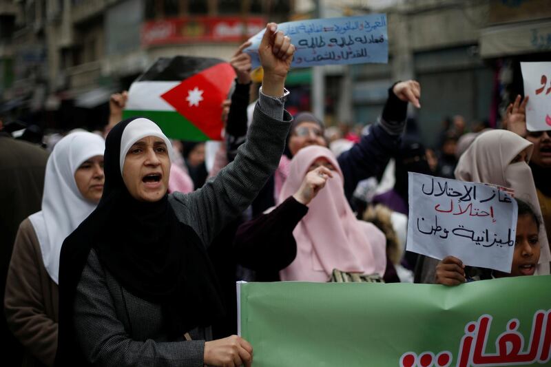 Demonstrators hold Jordanian national flag and chant slogans during a protest against a government's agreement to import natural gas from Israel, in Amman, Jordan. Reuters