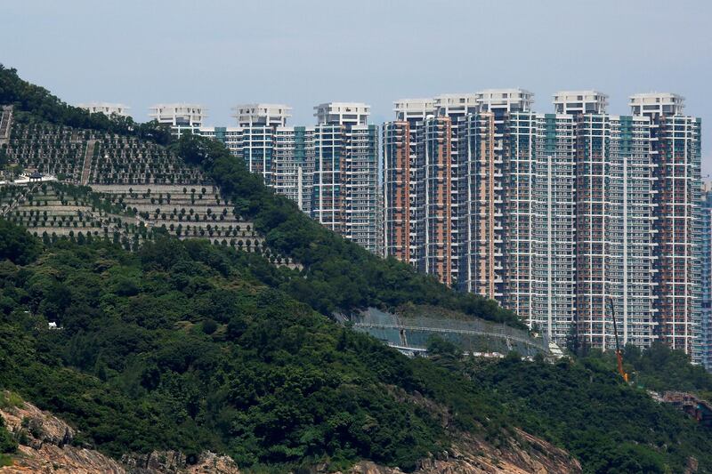 Private residential blocks are seen behind a cemetery at Tseung Kwan O district in Hong Kong, China September 15, 2018. Picture taken September 15, 2018.   REUTERS/Bobby Yip