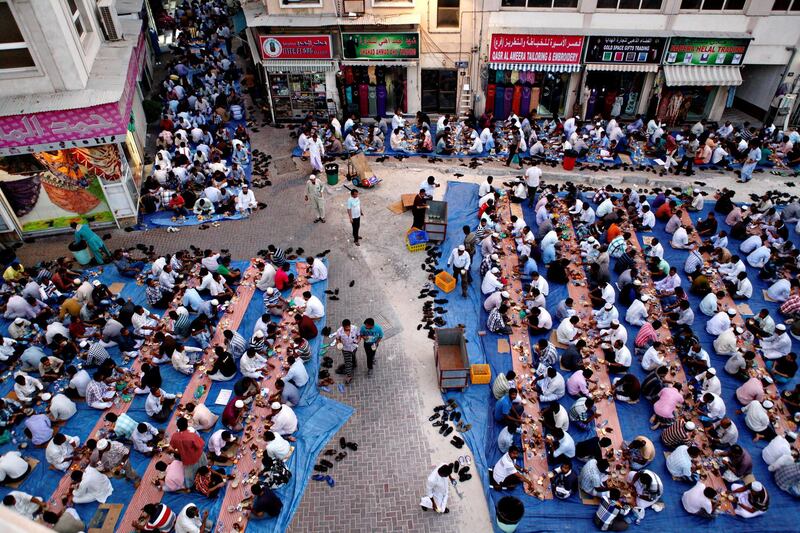 Dubai, July 31, 2013 - Thousands of men break fast together after Maghrib outside Masjid Kuwait Lootah Mosque in Deira, Dubai, July 31, 2013. (Photo by: Sarah Dea/The National, Story by: N/A) *** Local Caption ***  SDEA010813-ramadan_oldnew33.JPGSDEA010813-ramadan_oldnew33.JPG