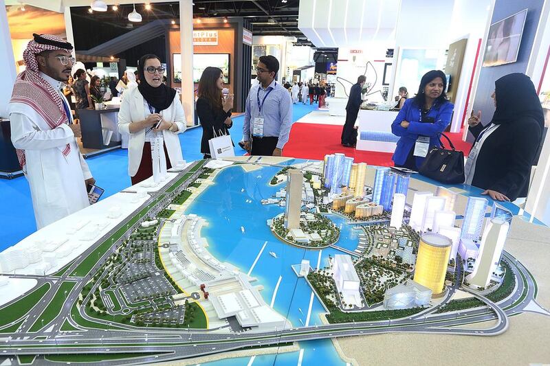 Visitors take a look at a scale model of the 10-year old Bahrain Bay project . Satish Kumar / The National