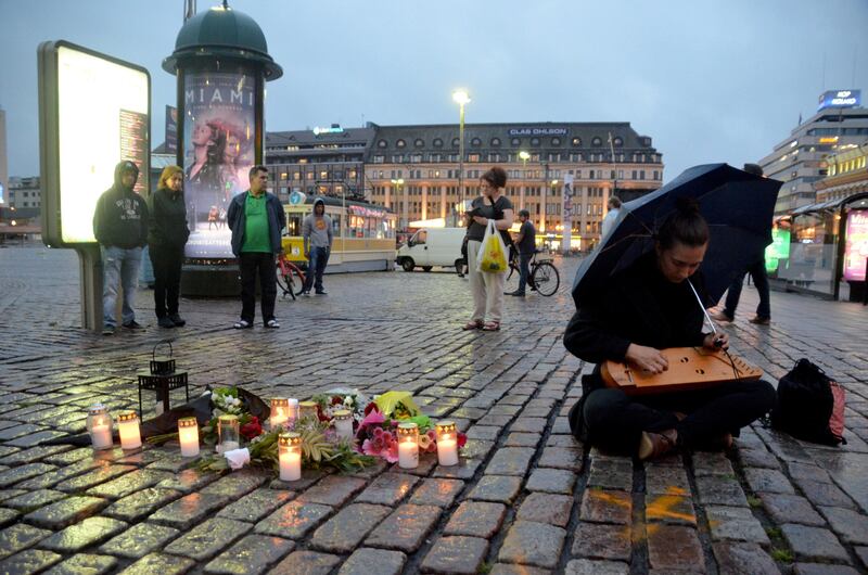 A woman plays a traditional Finnish string instrument, kantele, at the Market Square where several people were stabbed, in Turku, Finland August 18, 2017. REUTERS/Tuomas Forsell TPX IMAGES OF THE DAY