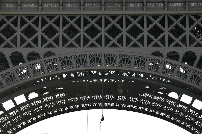 French athlete Anouk Garnier scales the Eiffel Tower in a bid to break the world record for rope climbing. AFP