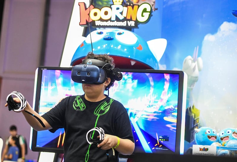Abu Dhabi, United Arab Emirates - A young boy plays virtual reality game, Kooring Wonderland at GamesCon, ADNEC. Khushnum Bhandari for The National