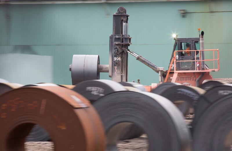 Rolls of steel are moved outside the ArcelorMittal Dofasco plant, an integrated steel producer, in Hamilton, Ontario, Canada, March 7, 2018.   REUTERS/Peter Power