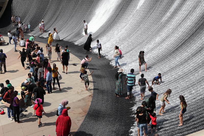 Visitors enjoy the water feature on the last day. Pawan Singh / The National