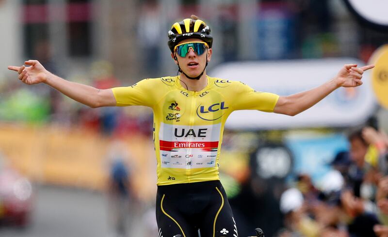 UAE Team Emirates rider Tadej Pogacar, wearing the yellow jersey, celebrates as he wins stage 18 of the Tour de France.