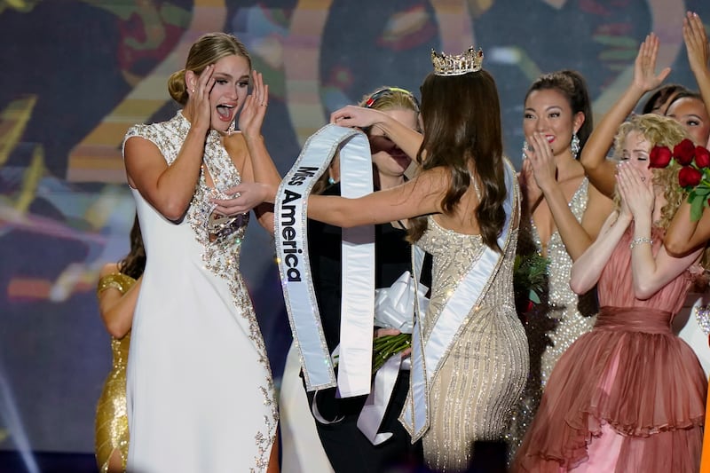 Stanke is presented with the Miss America 2023 sash by  Broyles