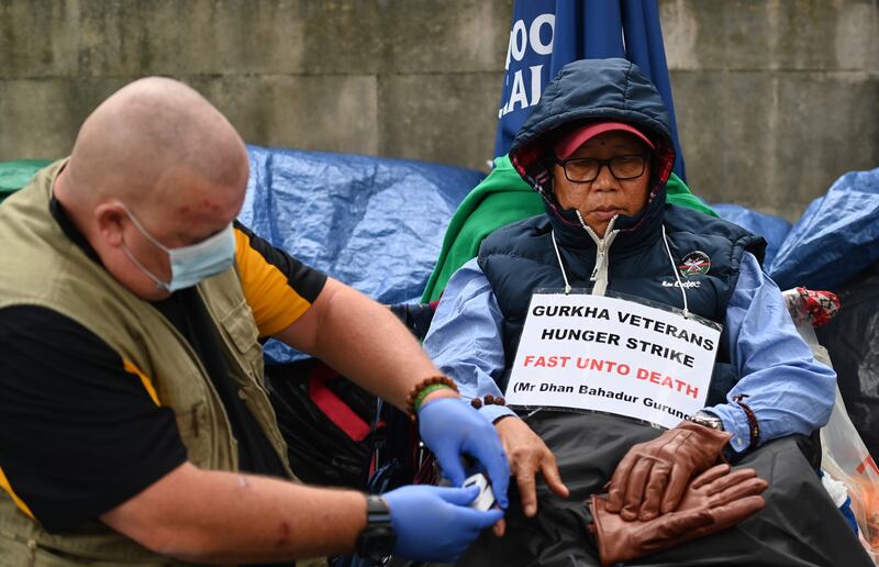 Former British Gurkha soldier Dhan Gurung (R), 60, is on hunger strike outside Downing Street in London. EPA.