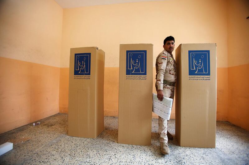 An Iraqi security member casts his vote at a polling station in Mosul, Iraq. Thaeir al-Sudani / Reuters