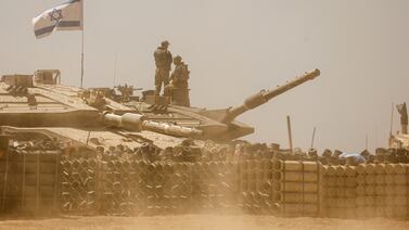 Israeli soldiers operate a tank near the Gaza border in southern Israel. Reuters