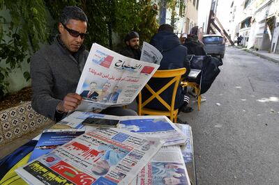 A Tunisian man reads a newspaper in Tunis on Tuesday after a crackdown that has targeted activists, former lawyers and a prominent businessman. AFP