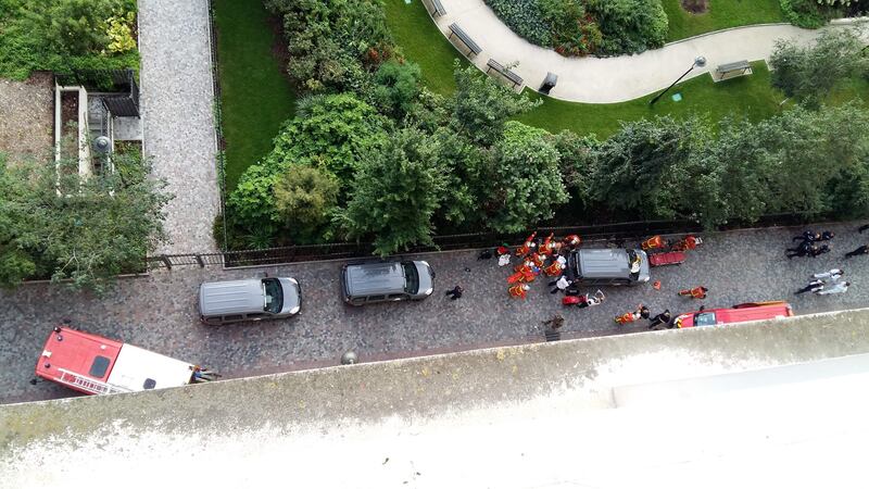 Officials and rescuers gather near vehicles after a car slammed into soldiers on patrol in Levallois-Perret, outside Paris. Thierry Chappe.