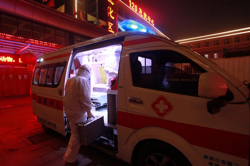A medical worker in protective suit gets onto an ambulance at a hospital in Xuanhua district of Zhangjiakou, Hebei province, China. Reuters