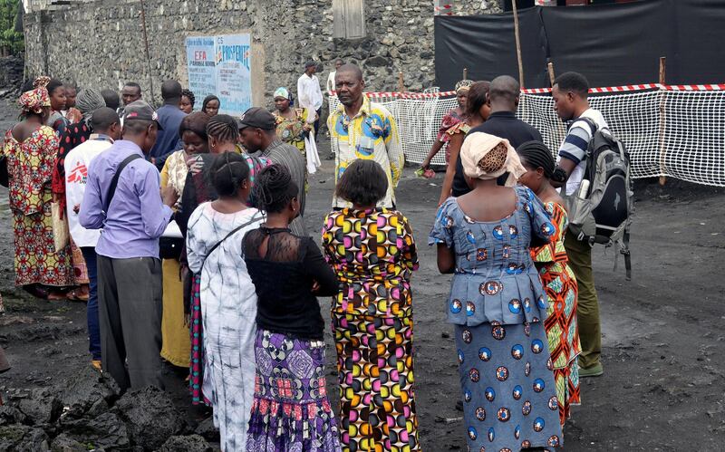 FILE PHOTO: Congolese residents gather around Medecins Sans Frontieres (MSF) health workers as they prepare the introduction of the second ebola vaccine produced by Johnson & Johnson, in Majengo neighborhood of Goma, Democratic Republic of Congo, November 14, 2019. REUTERS/Fiston Mahamba/File Photo