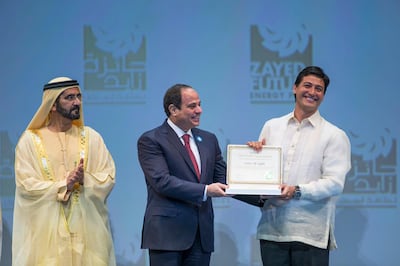 ABU DHABI, UNITED ARAB EMIRATES - January 19, 2015: HH Sheikh Mohammed bin Rashid Al Maktoum Vice-President Prime Minister of the UAE and Ruler of Dubai (L) and HE Abdel Fattah El-Sisi President of Egypt (C) present the Zayed Future Energy Prize Non-Profit Organisation award to Illac Diaz, Executive Director of Liter of Light (R) during the opening ceremony of the World Future Energy Summit, part of Abu Dhabi Sustainability Week at the Abu Dhabi National Exhibition Centre (ADNEC).

( Donald Weber / Crown Prince Court - Abu Dhabi )
--- *** Local Caption ***  20150119DW_16R1396.JPG